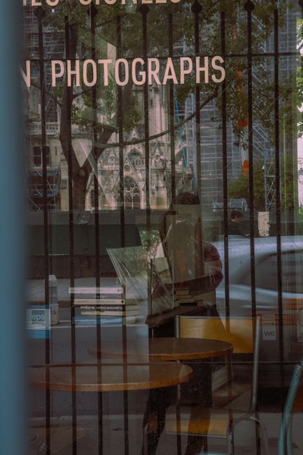 Artistic reflection of Paris street scene with books and architecture.