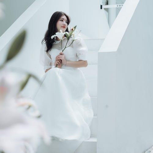 Bride in Wedding Dress Posing on Stairs