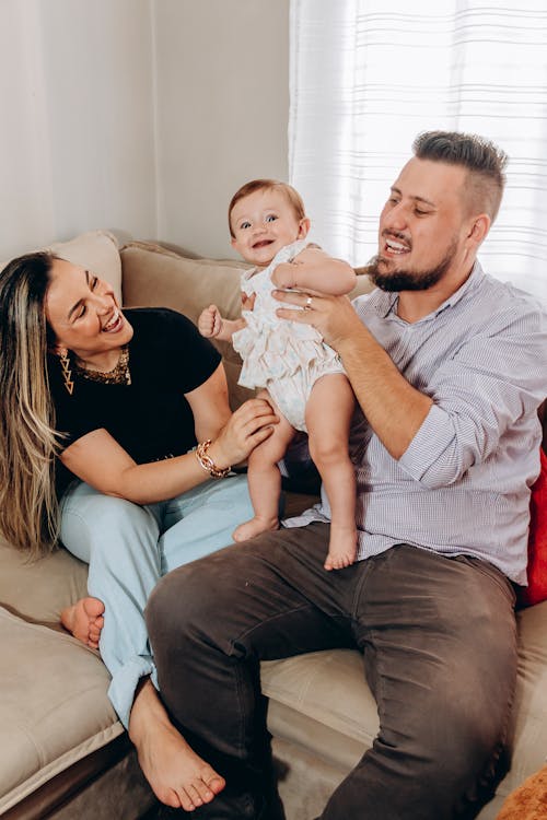 Photo of a Happy Family Having Fun on the Sofa