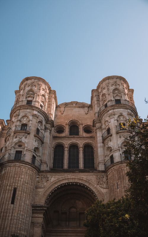 Free Explore the stunning Renaissance architecture of Málaga Cathedral's facade in sunny Spain. Stock Photo