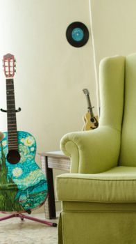 Cozy living room interior showcasing artistic guitars and a comfortable green sofa.