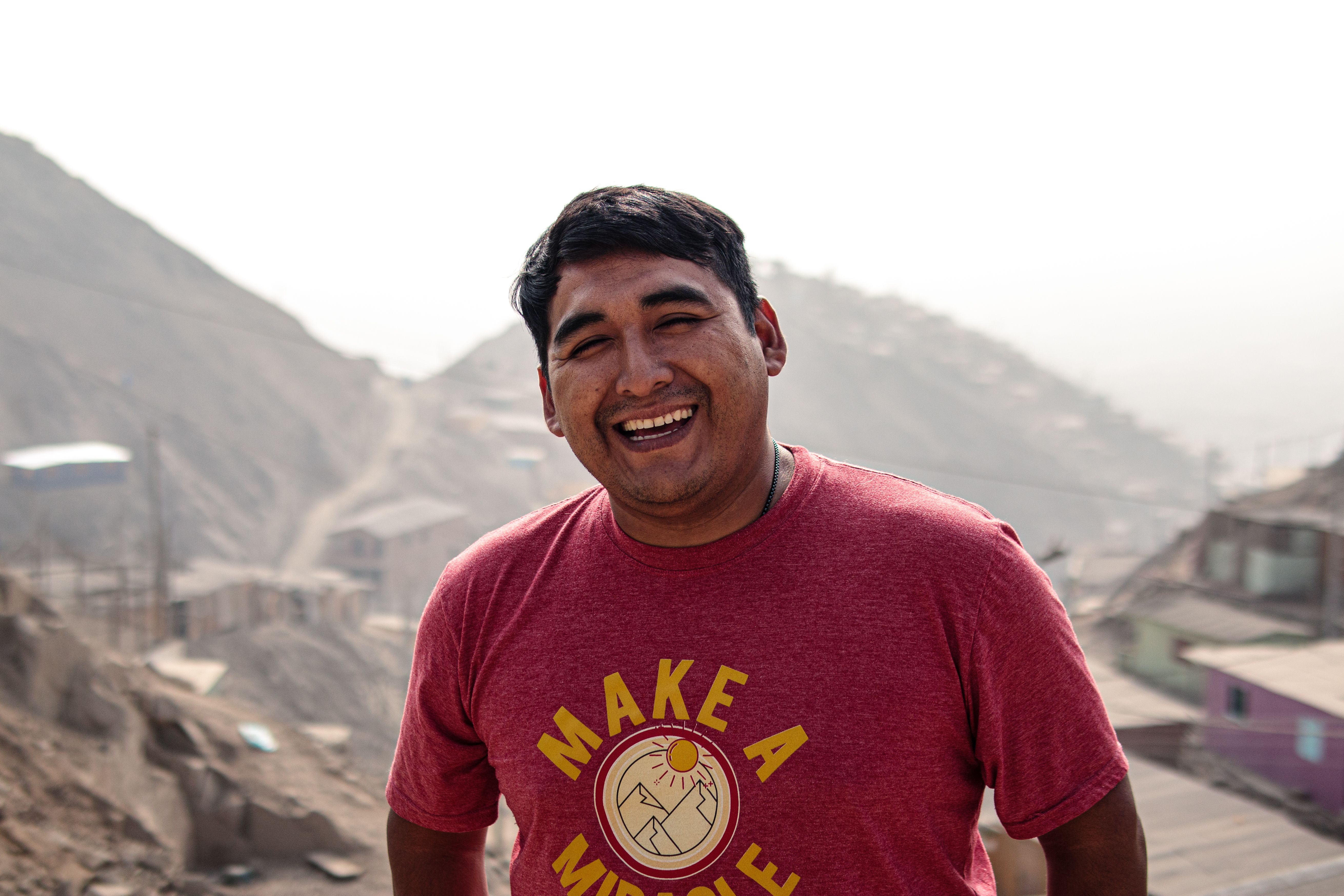 Vibrant portrait of a smiling man in San Juan de Lurigancho, Peru, capturing local life.