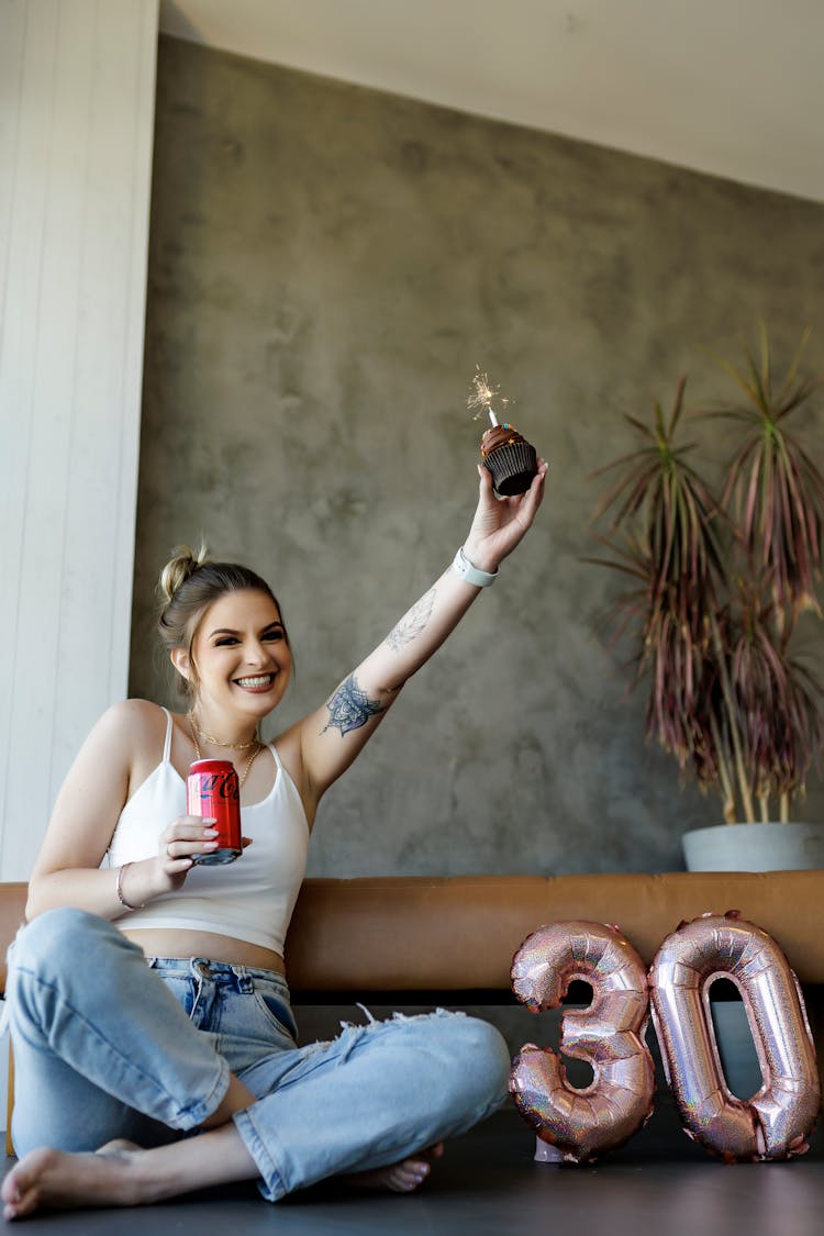 Happy Woman Celebrating Birthday With Cupcake