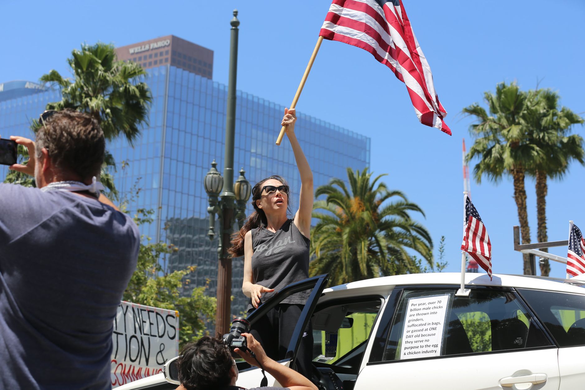 Los Angeles supporters gathering at Exposition Park near the Coliseum, with flags, food stalls, and afternoon sunlight