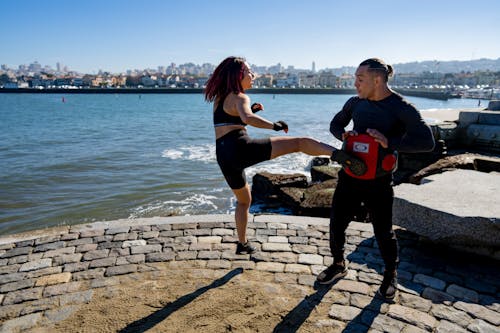 Woman Training Kickboxing in Seaside