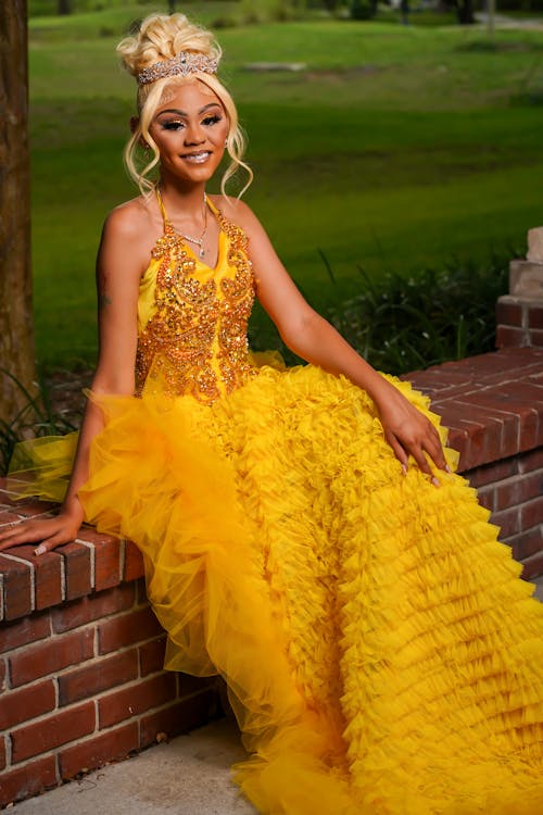 Woman in Dress Sitting on Wall