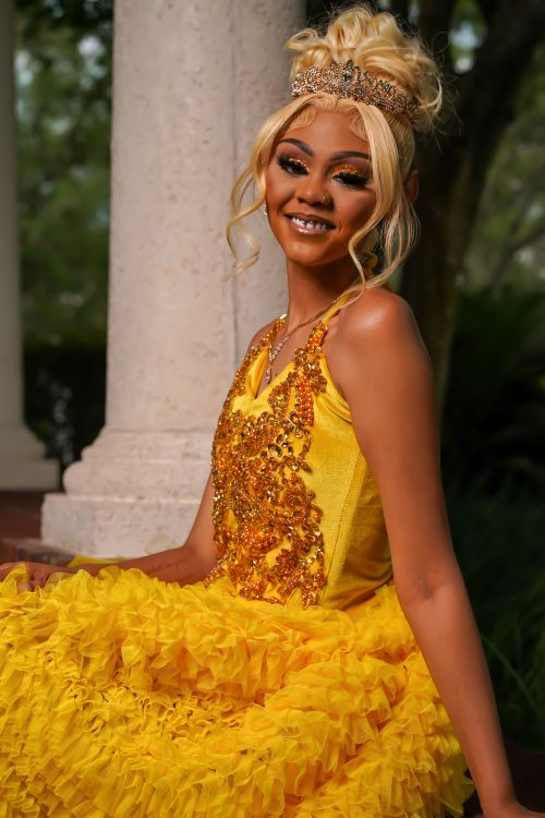 lady in yellow dress Woman Flowers Spring Garden Photoshoot: Joyful Model Poses Outdoors Yellow Maxi Dress, Holding Bouquet. Stock Photo Blonde Model in Yellow Dress