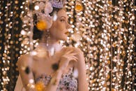 Woman Looking Sideways Surrounded By String Lights