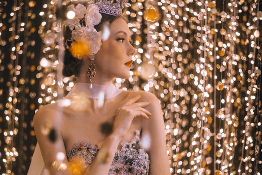 Woman Looking Sideways Surrounded By String Lights
