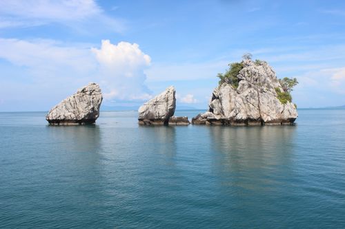 Free Stunning rock formations rise from the clear blue sea in Thailand, showcasing nature's beauty. Stock Photo