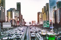 Photo of Cars on Road Between Buildings