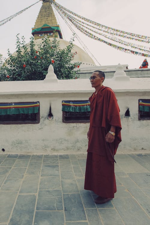 Buddhist Monk near Temple Wall