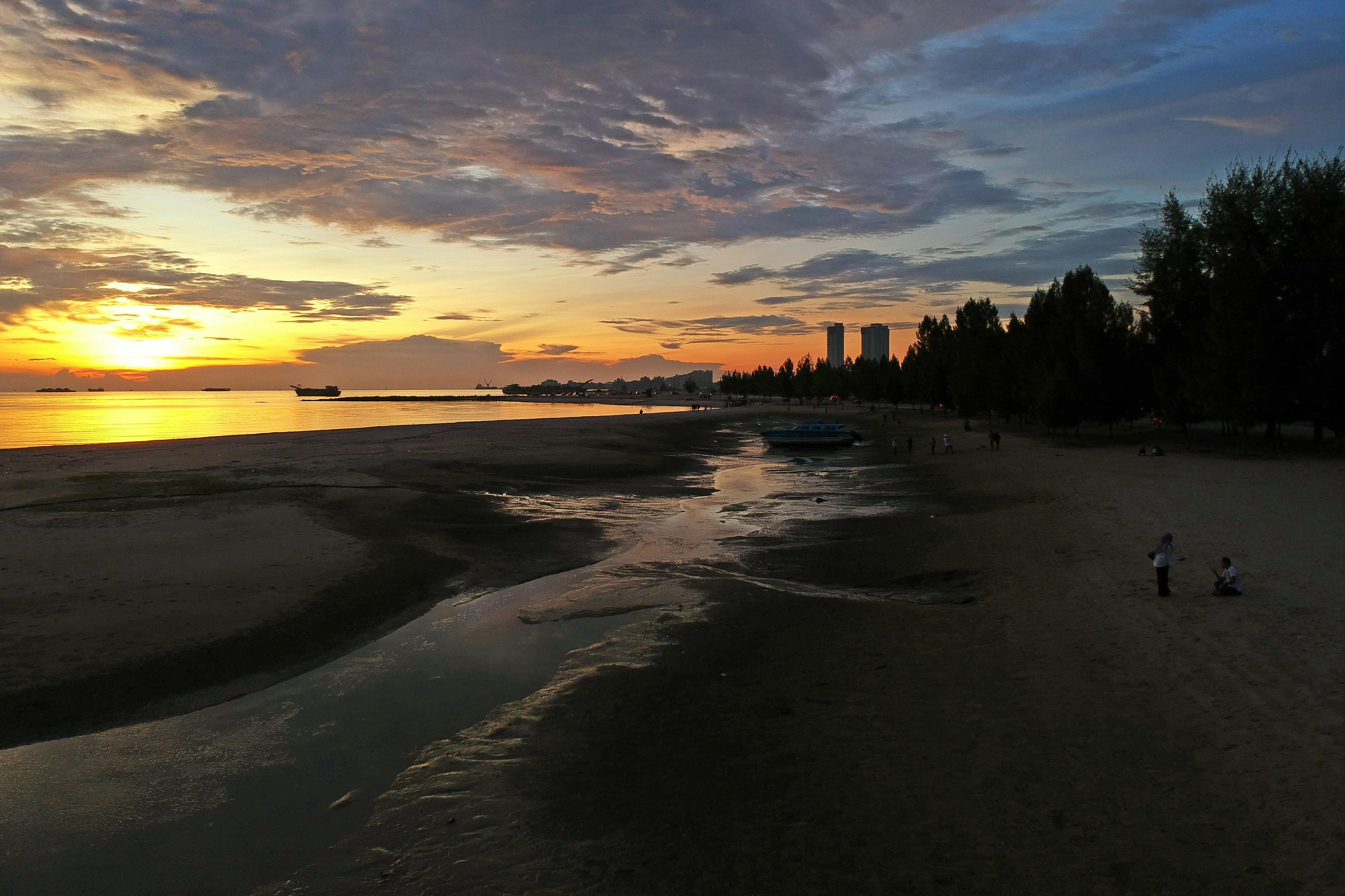 Breathtaking sunset view over the ocean at Melaka beach, Malaysia.