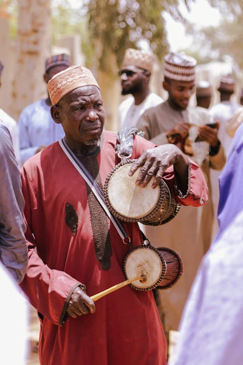 Man in Traditional Clothing with Drums