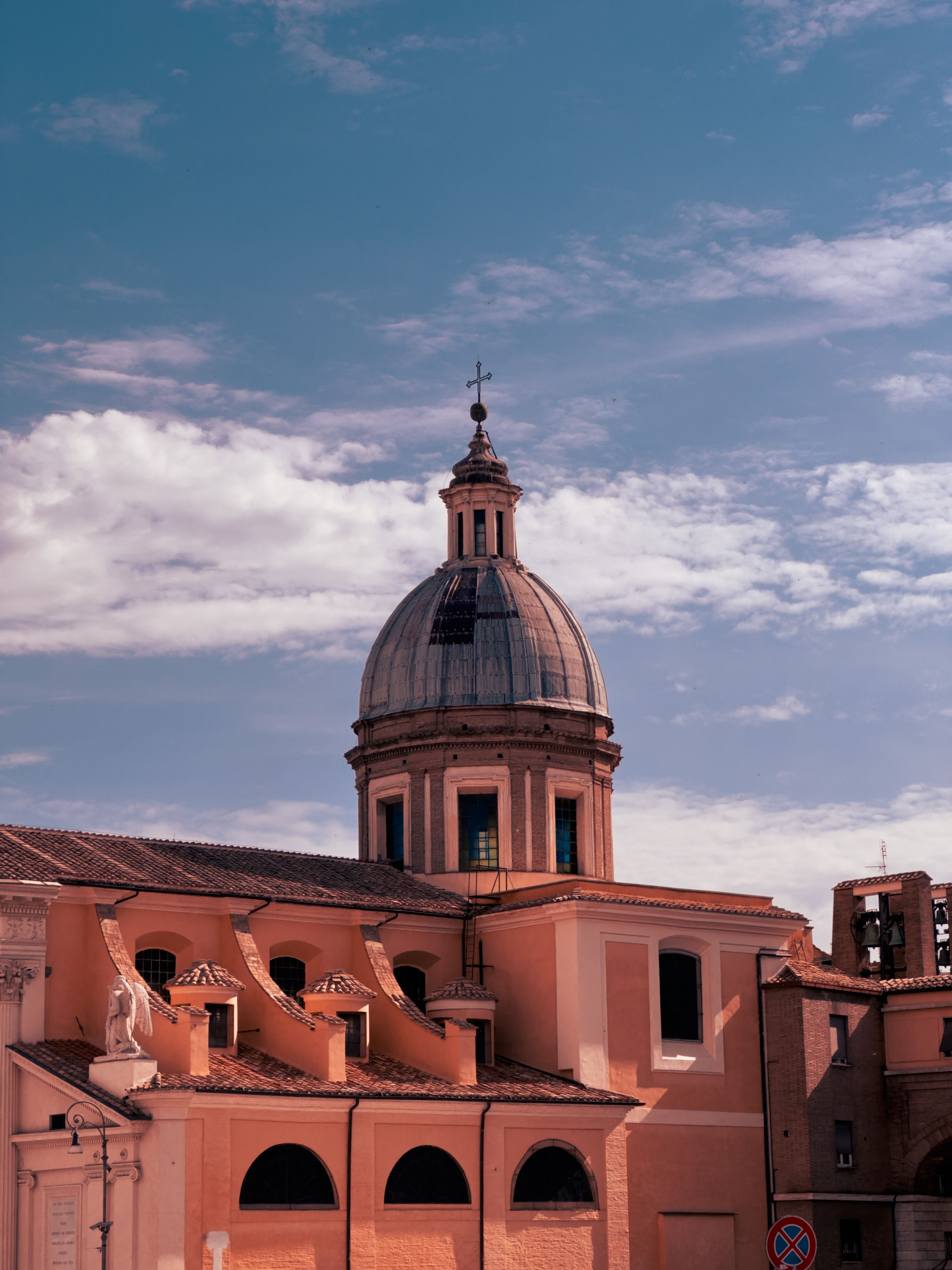 Beautifully captures the architectural elegance of a Roman church under clear skies.