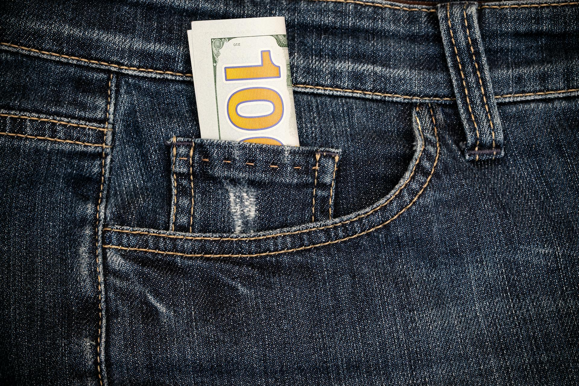 Several 100 us dollar bills in the pocket of jeans close up