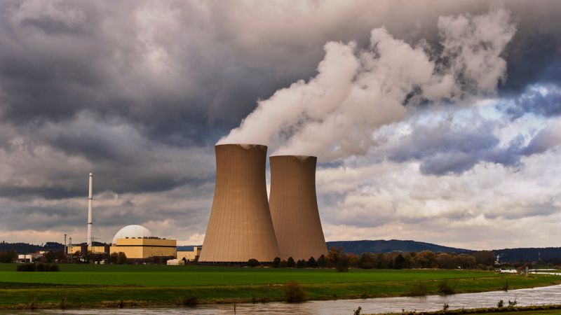 Scenic view of a nuclear power plant with cooling towers emitting steam in Hameln, Germany.