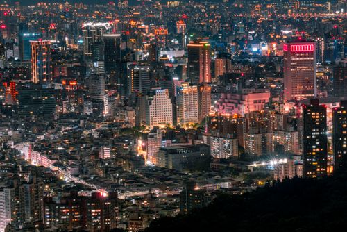 Free A breathtaking aerial view of an illuminated city skyline at night, showcasing vibrant lights and bustling urban life. Stock Photo