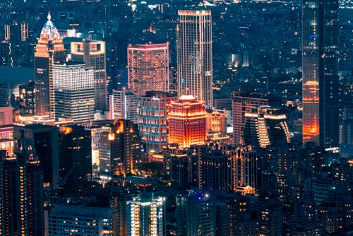 Free A vibrant and illuminated cityscape of Taipei at night showcasing modern skyscrapers and urban architecture. Stock Photo