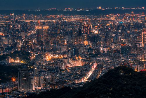 Free Captivating aerial cityscape at night with illuminated skyscrapers and busy streets. Stock Photo
