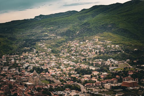 View of a Townscape and Green Hills in the Distance 