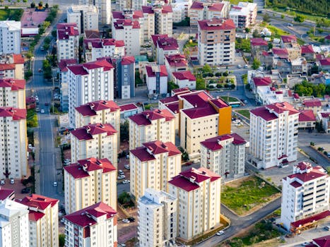 Aerial photo capturing a vibrant urban landscape with densely packed residential buildings and colorful rooftops.