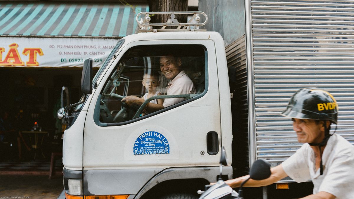 Box lorry with company door decals and contact details — an example of partial coverage on a Southeast Asian commercial vehicle