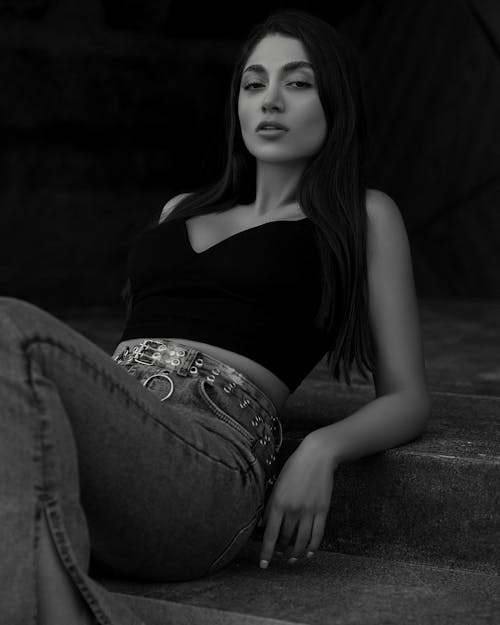 Young Woman in a Casual Trendy Outfit Sitting on Steps 