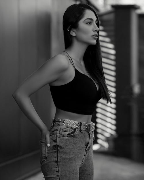 Black and White Picture of a Young Woman in a Crop Top and Jeans 