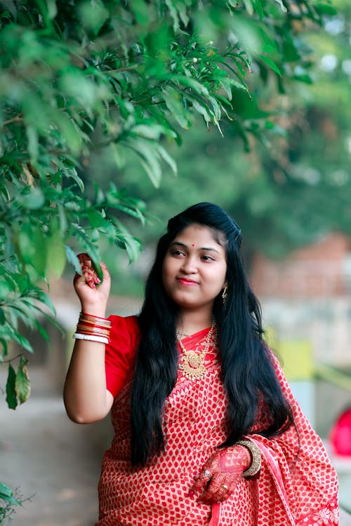 Bride in Red Sari with Traditional Henna Tattoos on Hands