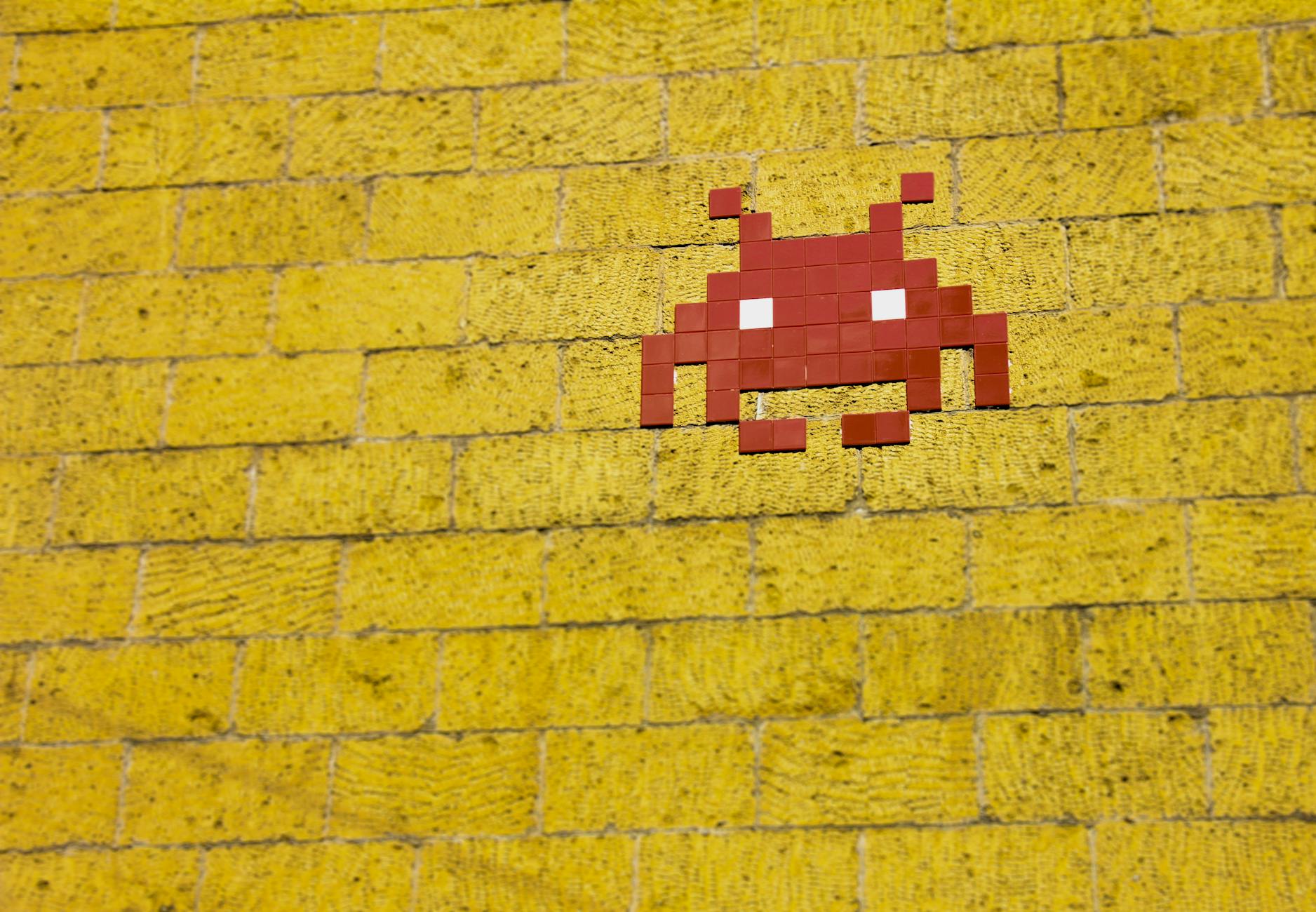 Space Invader on brick wall (public domain image)