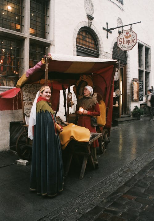 Woman Wearing Black Robe Standing Near Brown Stall