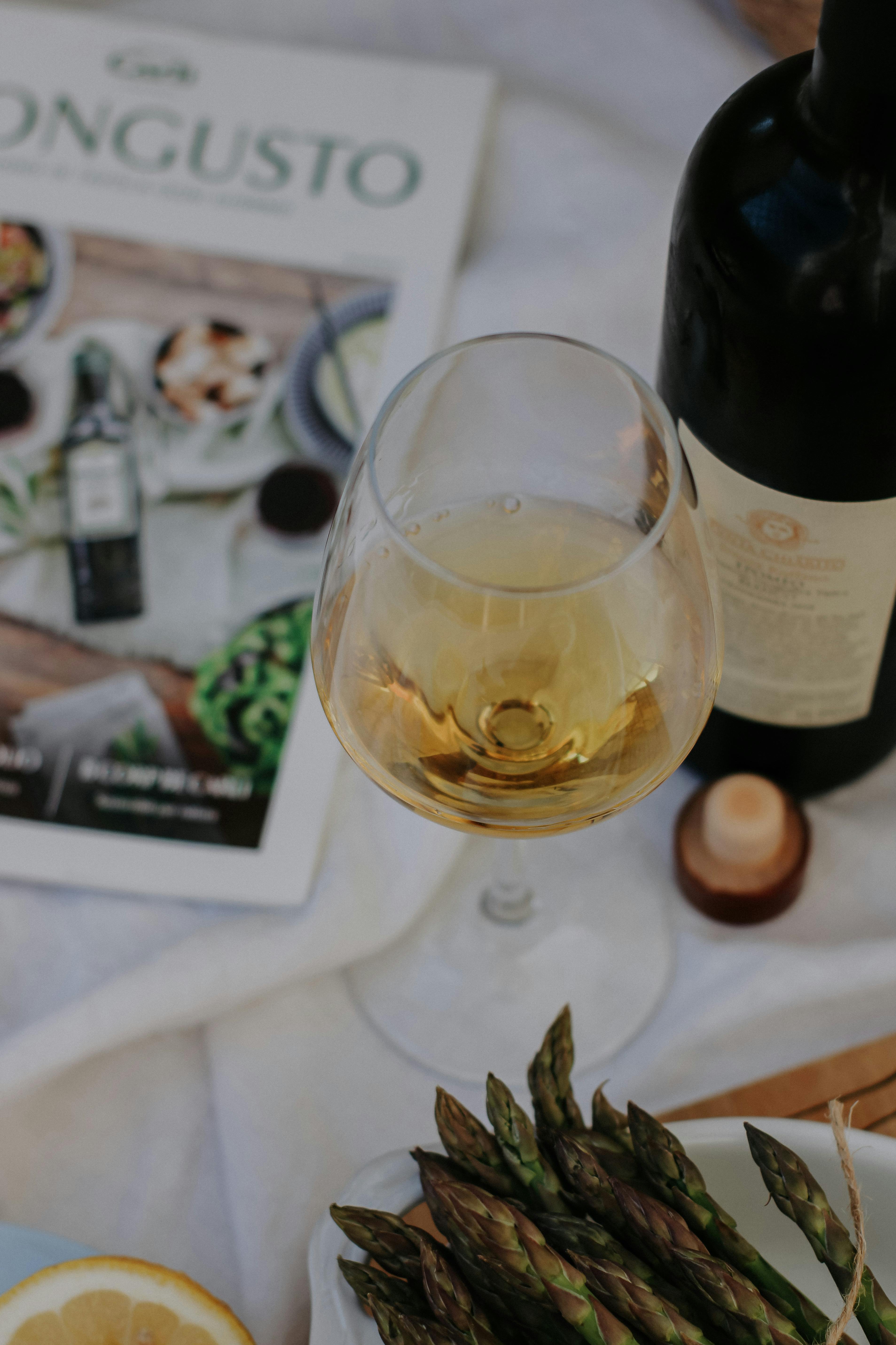 White Wine Served in Glass on White Tablec · Free Stock Photo