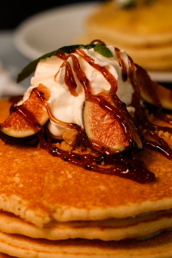 Pancakes drizzled with syrup — photo by Kuiyibo Campos on Pexels