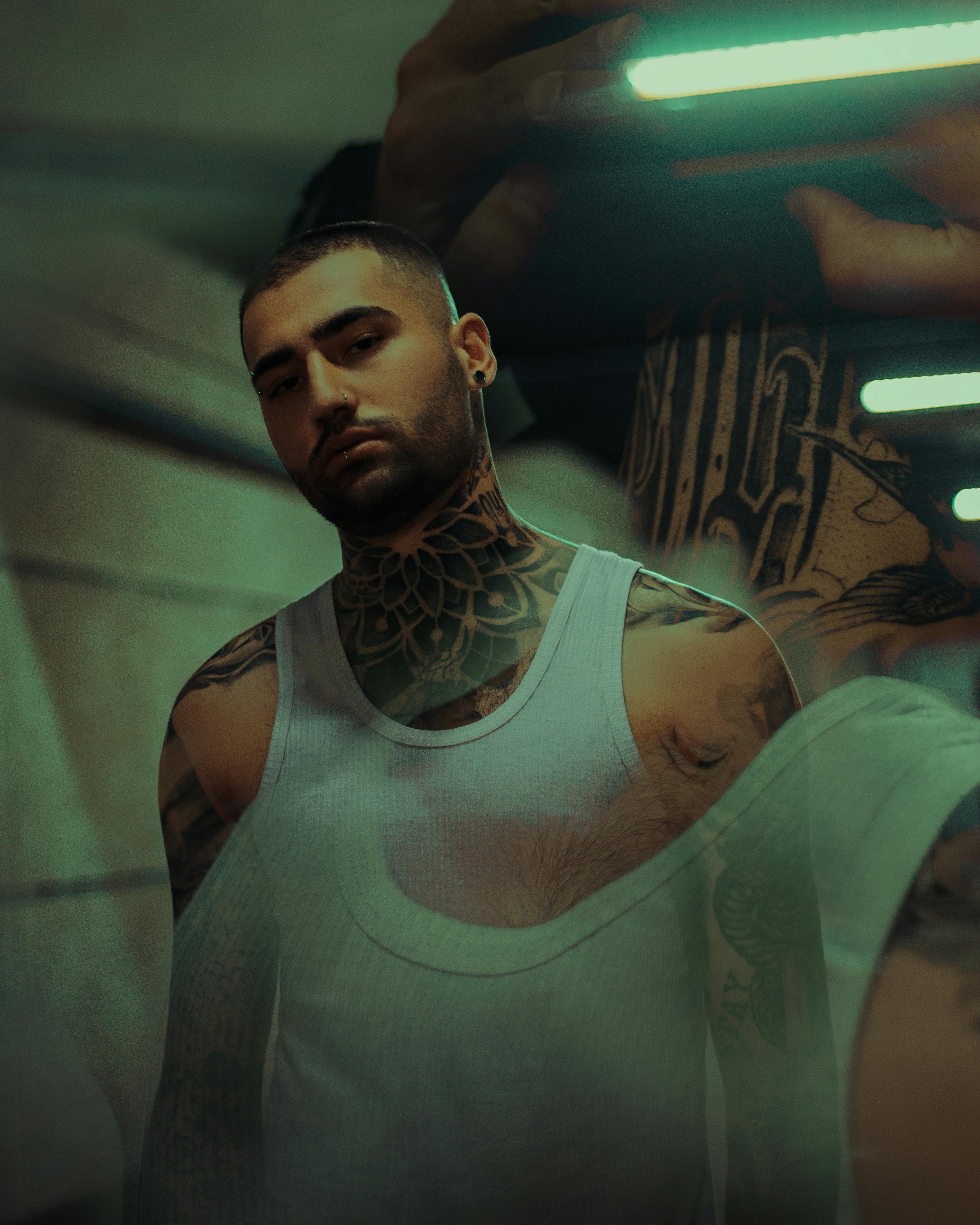 superimposed images of tattooed man wearing tank top