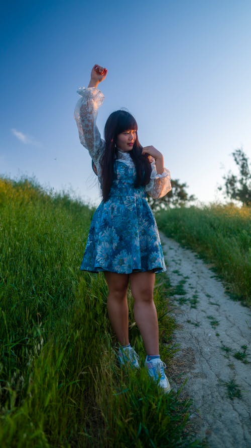 Woman in Dress Standing on Footpath