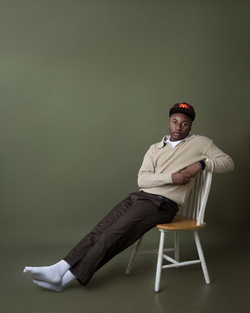 Stylish Man Sitting on Chair in Studio