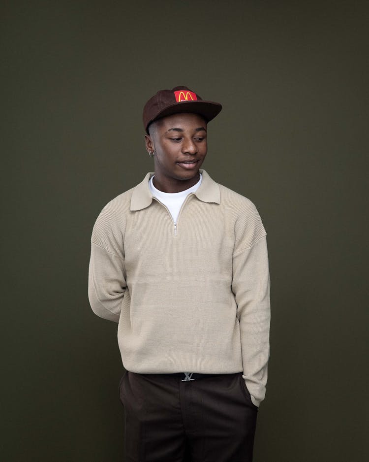 Young Man In Hat Posing In Studio