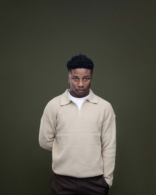 Young Man Posing on Green Studio Background
