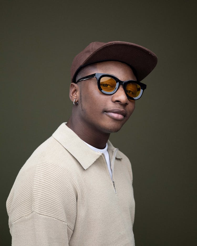 Man In Hat And Sunglasses Posing In Studio