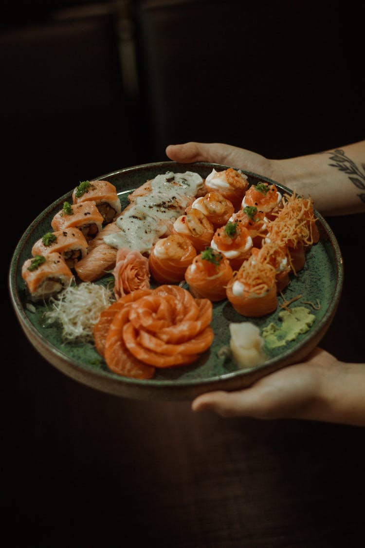 Woman Hands Holding Sushi Plate