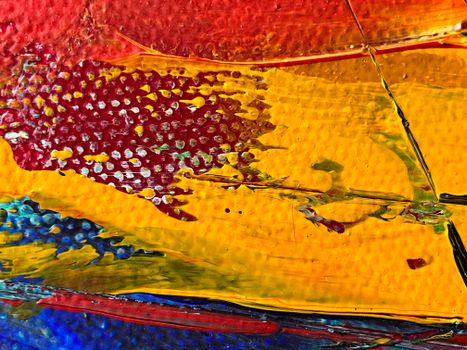 Close-up of vibrant, colorful abstract painting with rich textures and layers of paint.