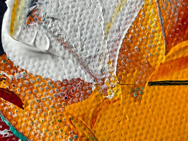 Close-up Of White And Orange Paint Stains On Canvas