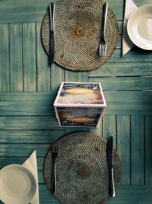 Free Top View of a Wooden Table with Plates and Cutlery at the Restaurant  Stock Photo