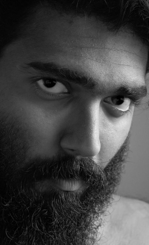 Free Close-up black and white portrait showcasing a bearded man's intense gaze. Perfect for artistic and expressive themes. Stock Photo