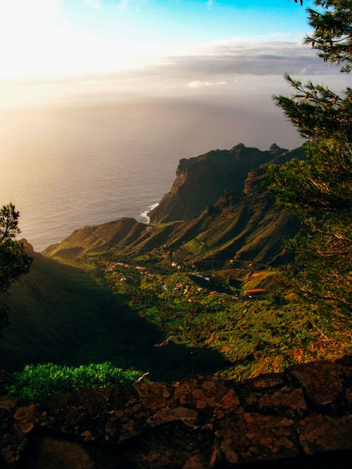 Free A stunning aerial view of coastal mountains and lush valleys at sunset with dramatic lighting. Stock Photo