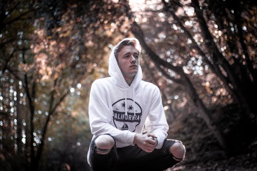 Man in white hoodie Squatting