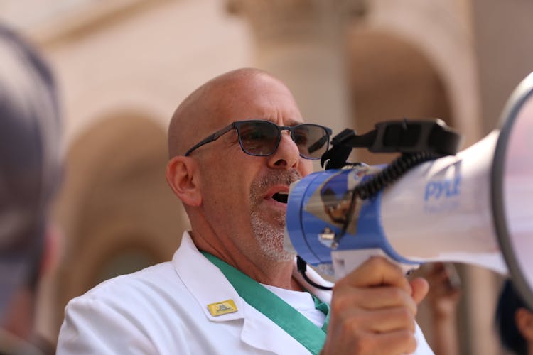 Bald Man Speaking With Megaphone