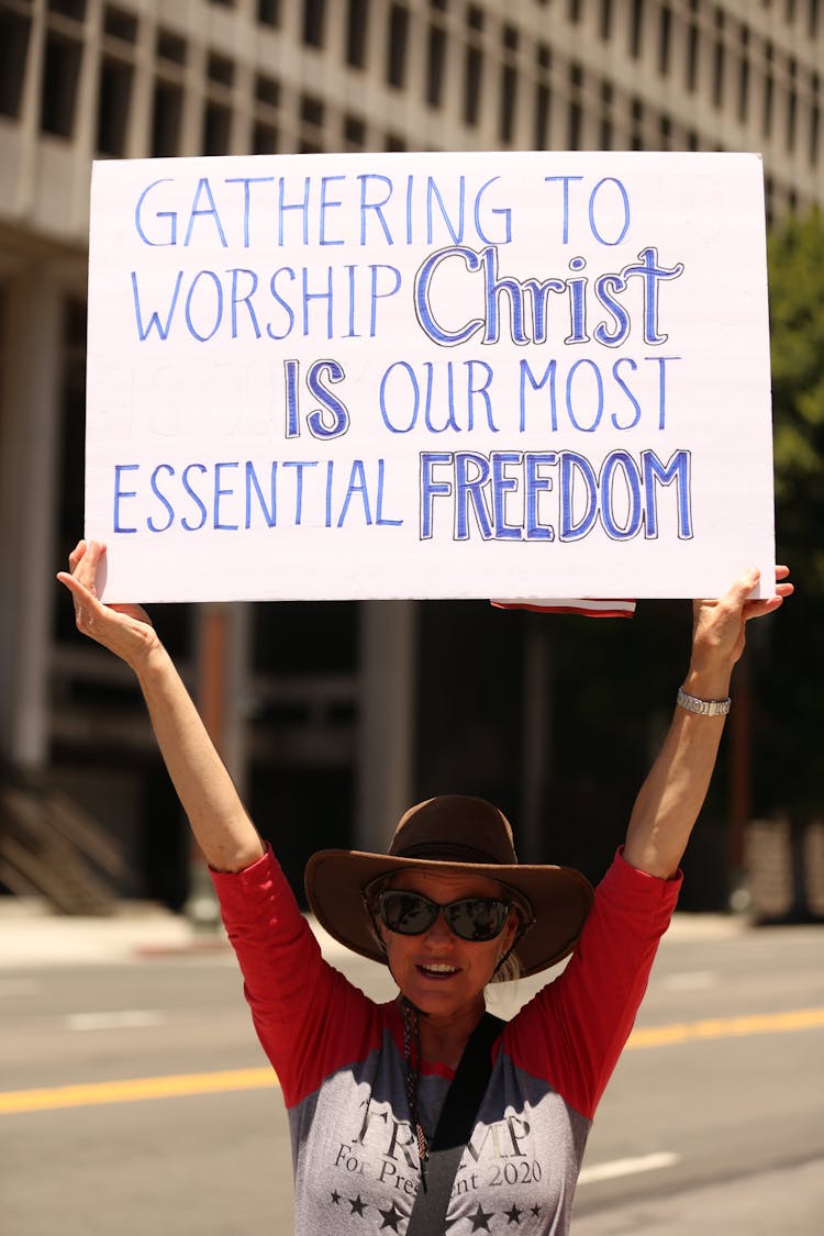 Christian Woman Holding A Banner On The Street 