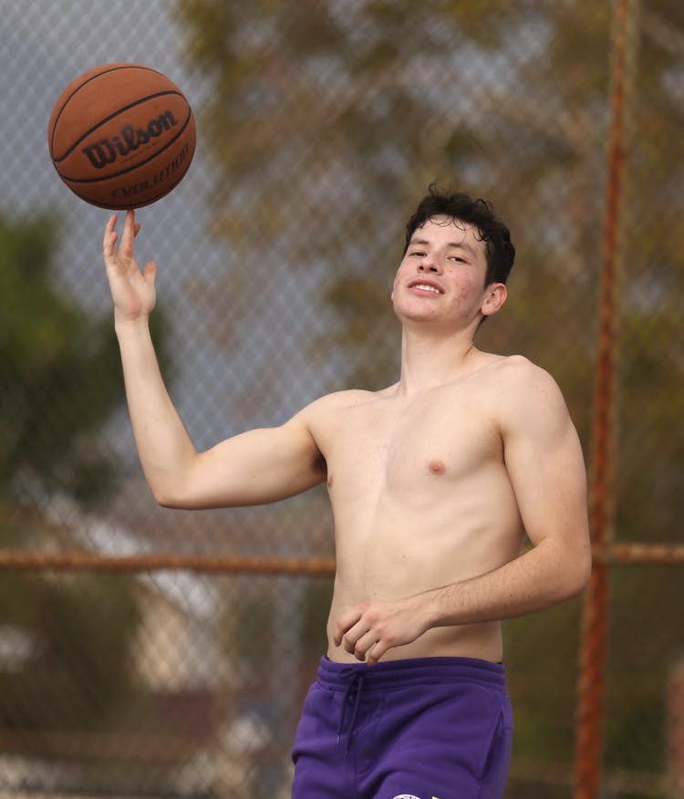 Teenager Playing Basketball